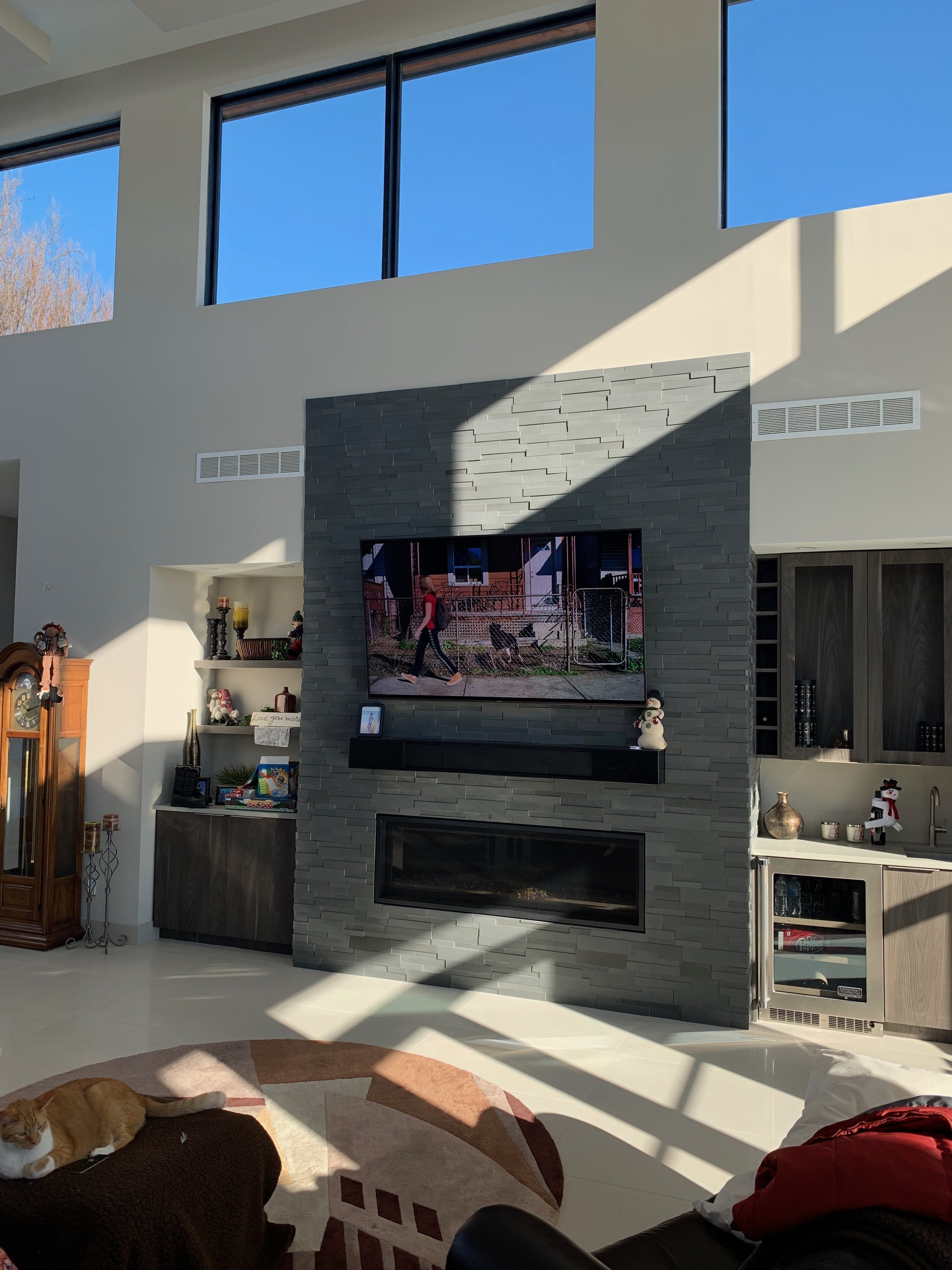 Norstone Aksent 3D Stone Panels in Ash Grey used on a modern fireplace in a large open loft style space